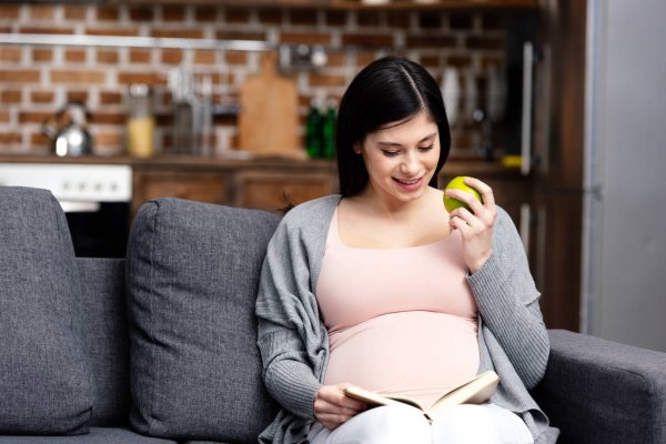 depositphotos 187717898 stock photo smiling young pregnant woman eating